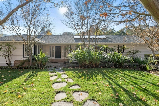 ranch-style house with a front lawn