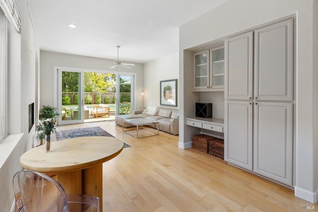 living room with ceiling fan and light hardwood / wood-style floors