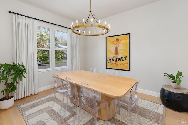 dining space featuring light hardwood / wood-style floors and a chandelier