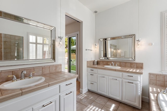 bathroom featuring tile patterned flooring, vanity, and tasteful backsplash