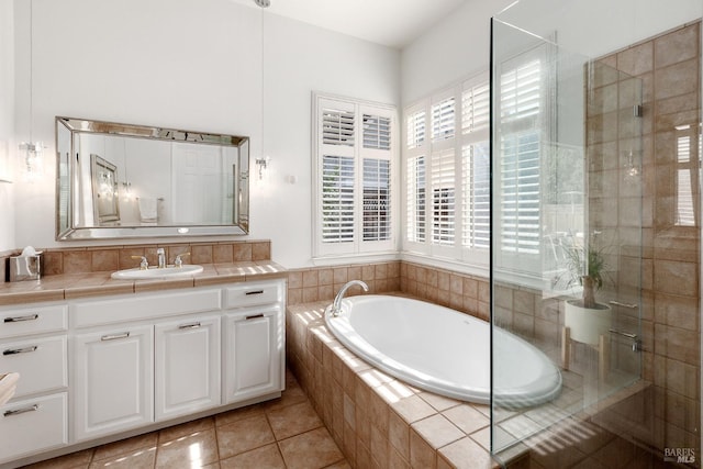 bathroom featuring tile patterned floors, vanity, and independent shower and bath