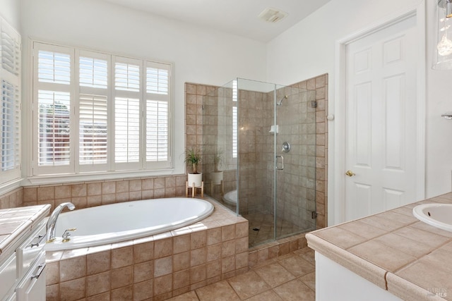 bathroom featuring separate shower and tub, tile patterned flooring, and vanity