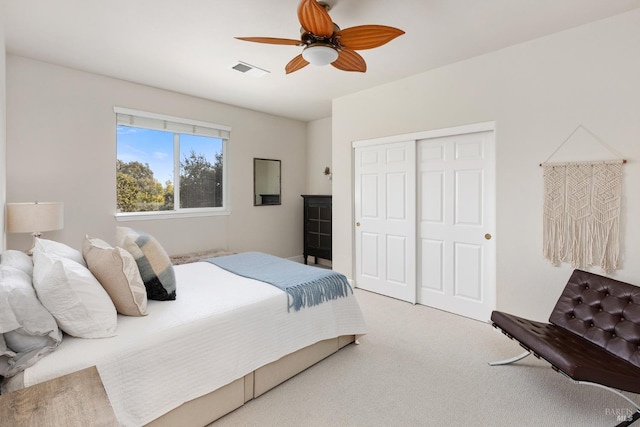 carpeted bedroom featuring a closet and ceiling fan