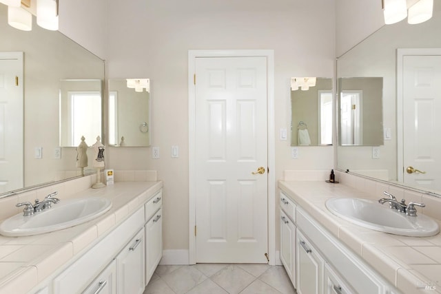 bathroom with tile patterned flooring and vanity