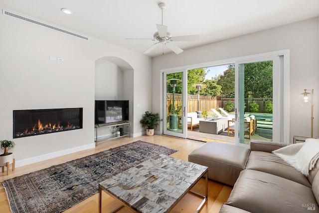 living room featuring ceiling fan and light wood-type flooring