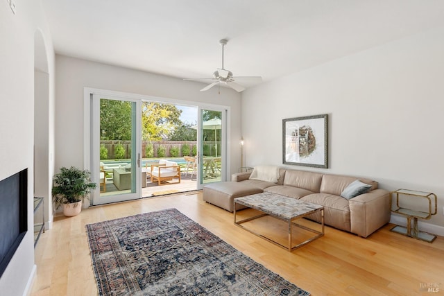 living room featuring hardwood / wood-style flooring and ceiling fan