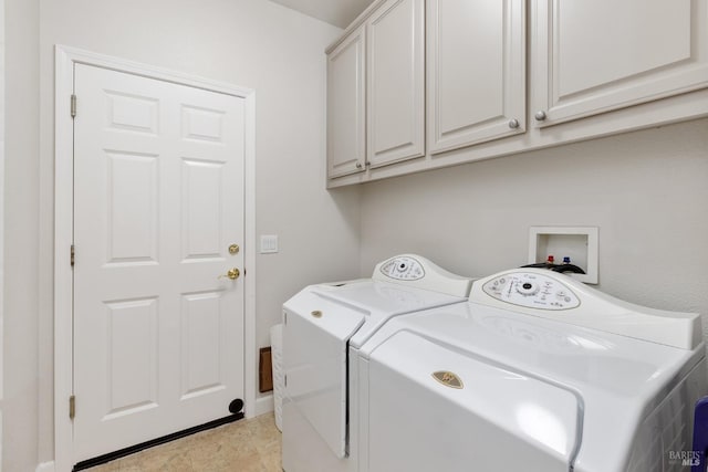 laundry room with cabinets and washing machine and clothes dryer