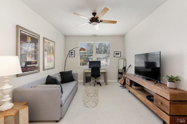 carpeted living room with ceiling fan