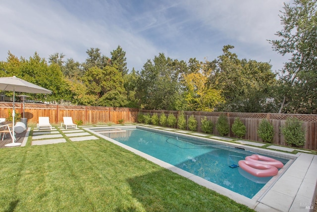 view of swimming pool featuring a lawn and a patio area