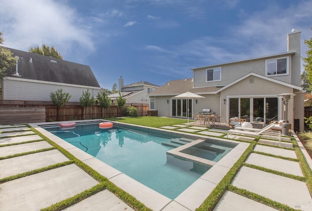 view of swimming pool featuring an in ground hot tub and a patio