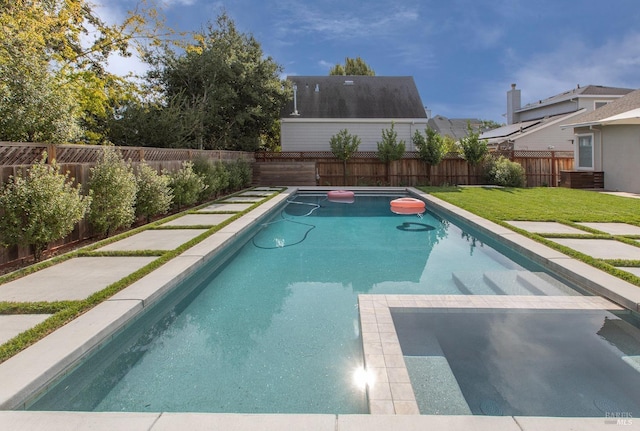 view of swimming pool with a yard