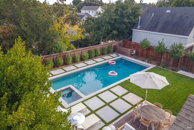 view of swimming pool with a patio area, an in ground hot tub, and a yard