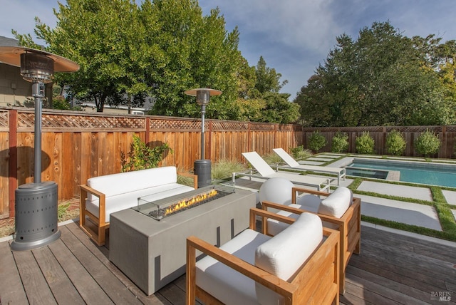 wooden terrace featuring a fenced in pool and an outdoor fire pit