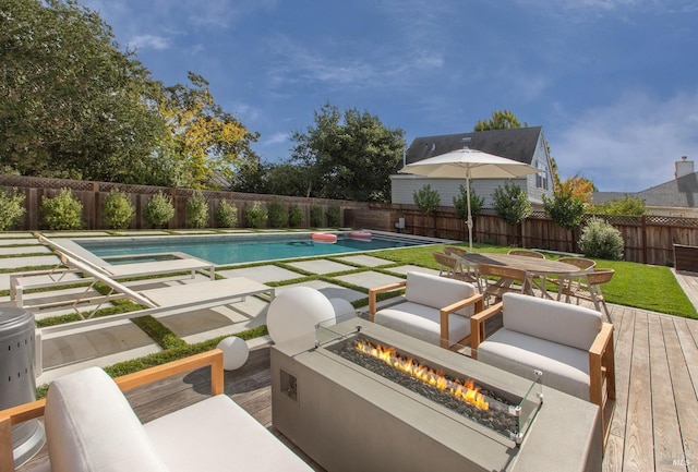 view of pool with an outdoor fire pit and a wooden deck