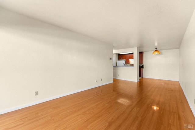 unfurnished living room featuring hardwood / wood-style floors