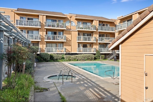 view of swimming pool with a community hot tub