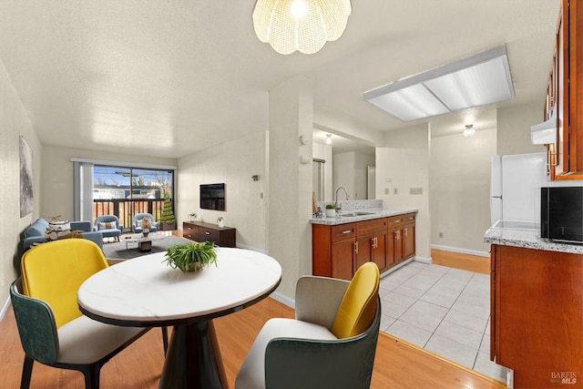 tiled dining space featuring sink and ceiling fan