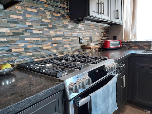 kitchen featuring backsplash, high end stainless steel range, and sink