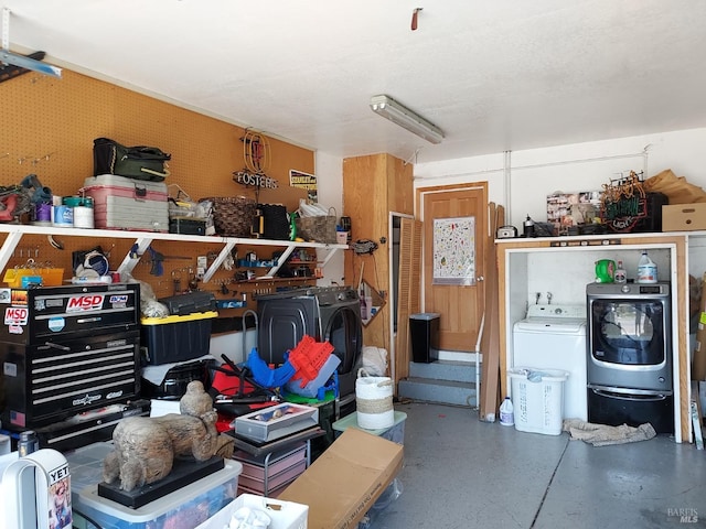 garage with washing machine and dryer and a workshop area