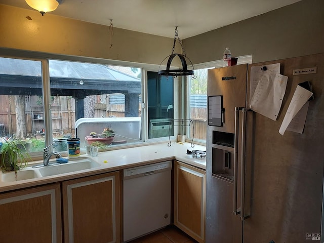 kitchen featuring stainless steel fridge with ice dispenser, sink, white dishwasher, and tile patterned flooring