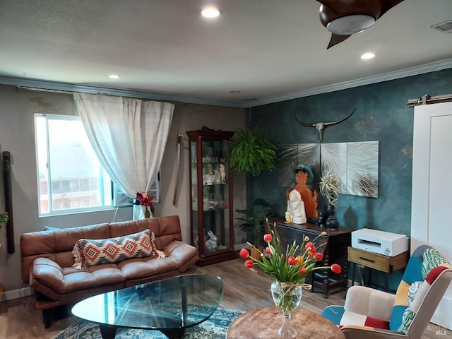 living room with hardwood / wood-style flooring and ornamental molding