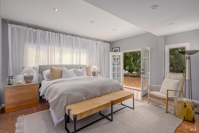 bedroom with french doors and wood-type flooring