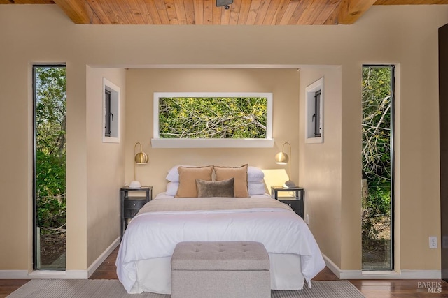 bedroom featuring wood-type flooring and wood ceiling