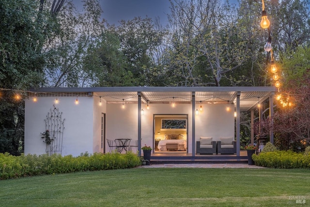 back of property featuring a lawn