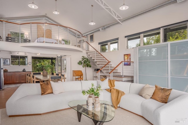 living room with a towering ceiling and a wealth of natural light