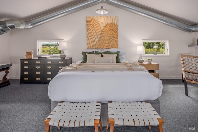 bedroom featuring dark carpet and lofted ceiling