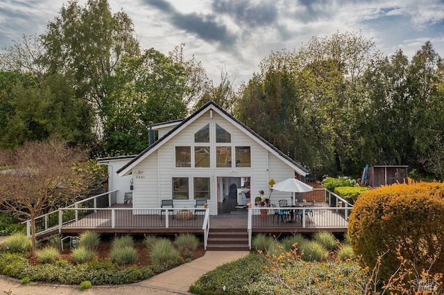 rear view of house with a wooden deck
