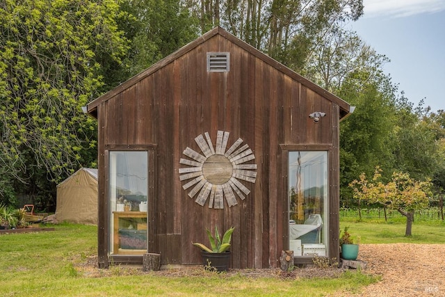 view of outbuilding with a lawn