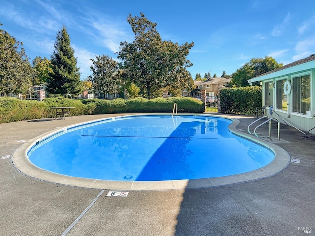 view of pool featuring a fenced in pool, a patio area, and fence