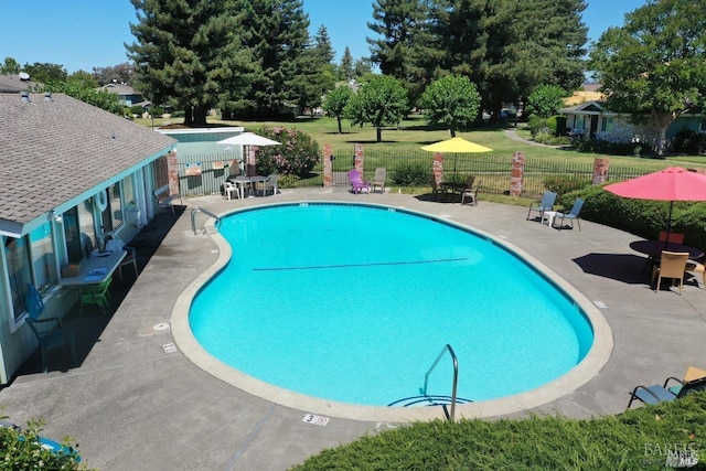 pool with a yard, a patio area, and fence