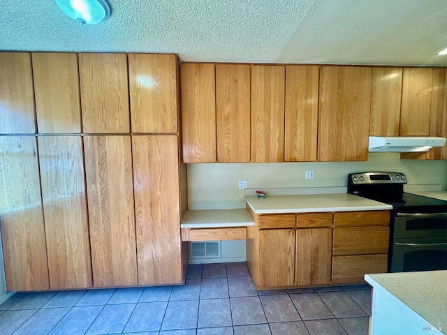 kitchen featuring visible vents, light countertops, under cabinet range hood, double oven range, and light tile patterned flooring