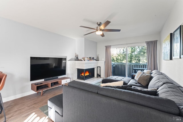 living room featuring ceiling fan and hardwood / wood-style floors