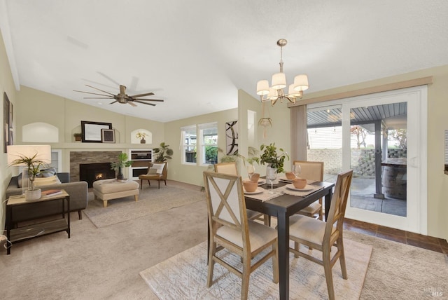 dining area with light colored carpet, lofted ceiling, and ceiling fan with notable chandelier