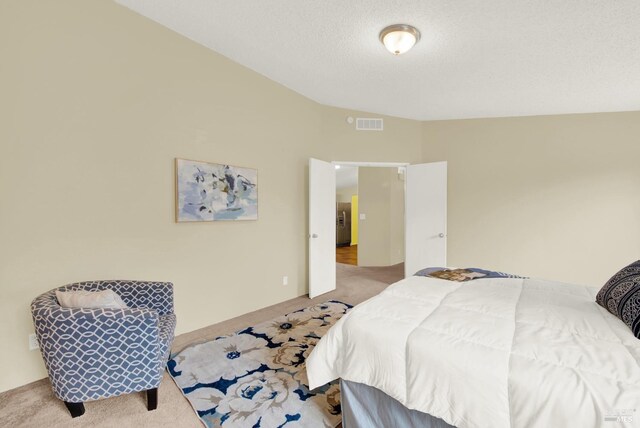 carpeted bedroom with a textured ceiling