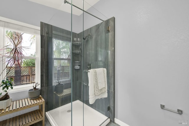 bathroom with a shower with door