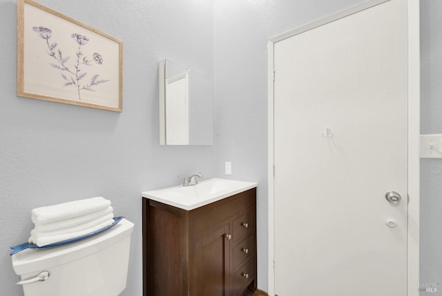 bathroom with toilet and vanity