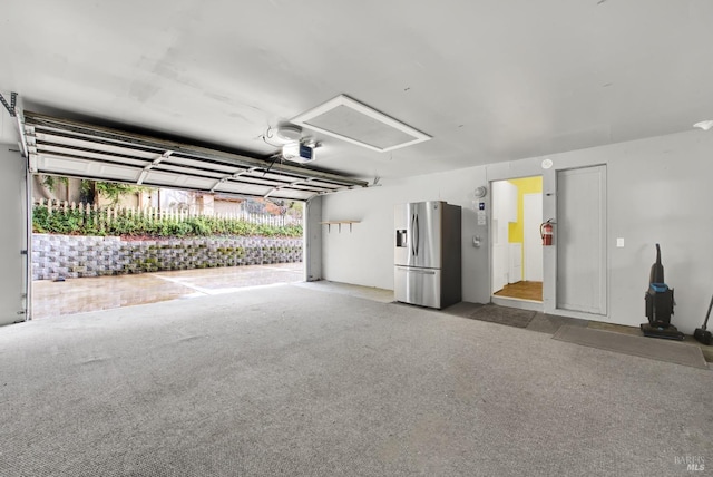 garage with stainless steel refrigerator with ice dispenser