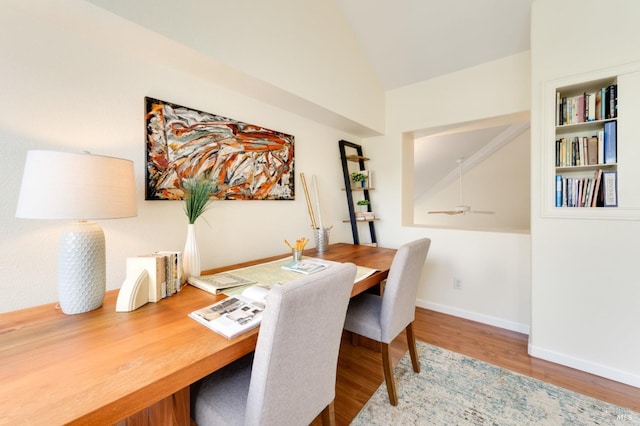 dining room with hardwood / wood-style flooring, vaulted ceiling, and ceiling fan