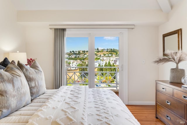 bedroom with access to exterior and light wood-type flooring