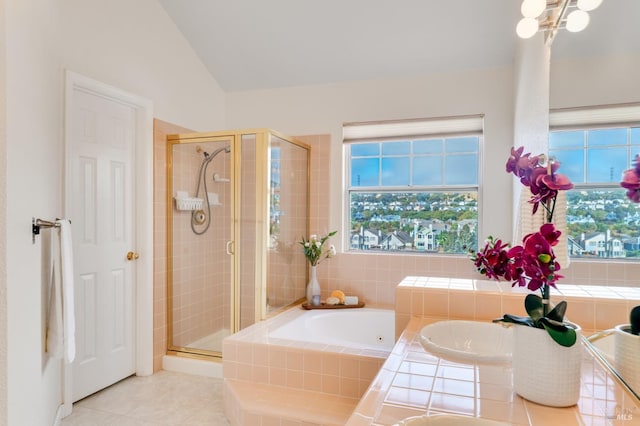 bathroom featuring tile patterned floors, shower with separate bathtub, and vaulted ceiling