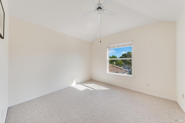 carpeted empty room with ceiling fan and vaulted ceiling