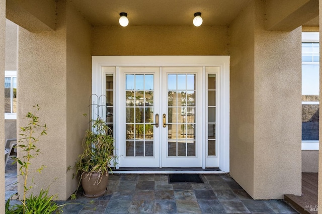 view of exterior entry featuring french doors