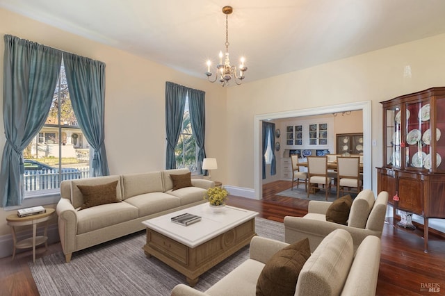 living room with wood-type flooring and an inviting chandelier