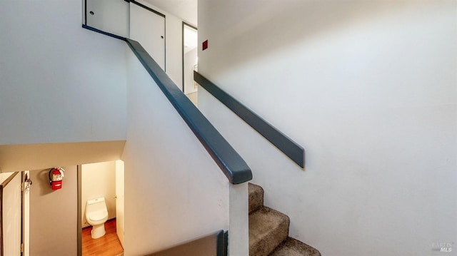 stairs featuring wood finished floors