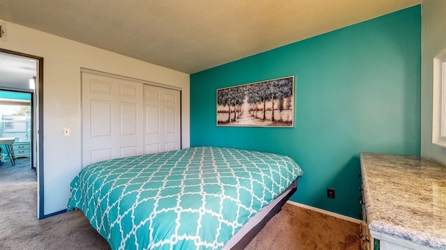 carpeted bedroom with baseboards and a closet