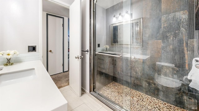 bathroom with vanity, a shower stall, and tile patterned flooring